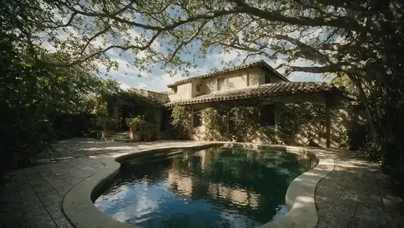 Courtyard plunge pool at a 1920s Mediterranean-revival house with patterned tile surround